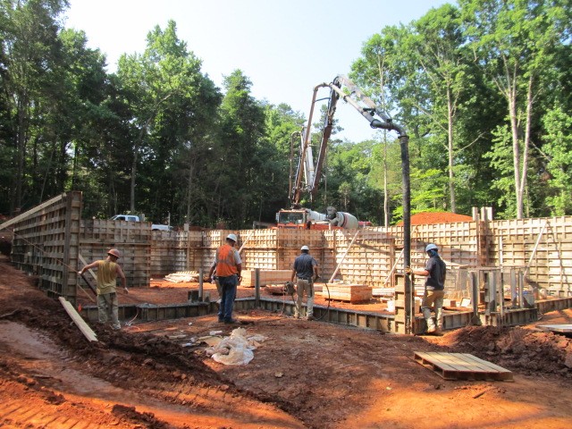 Foundation Forms being filled with concrete from pump truck